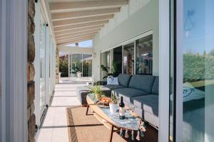 ペスキエーラ・デル・ガルダにあるVilla Dolce Peschieraのソファとテーブル付きのパティオ