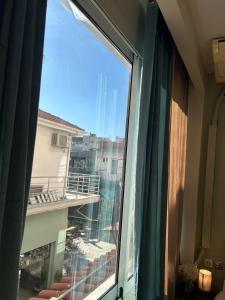 a view of a balcony from a window at Alpha apartment H1 in Serres