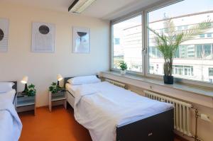 a hospital room with two beds and a window at MZK Maier Inexpensive and central in Pforzheim