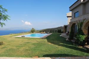 a house with a yard with a swimming pool at Sea & Serenity in Varnávas