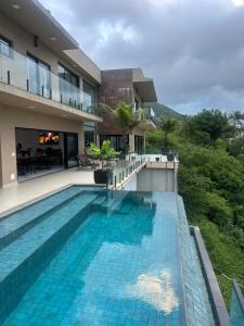 a swimming pool in front of a building at Maluhia Ilhabela 5 in Ilhabela