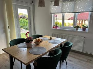 a wooden table in a room with chairs around it at Village house & Micro Winery in Sîntioana de Mureş