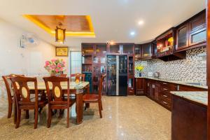 a kitchen with a table and chairs and a refrigerator at Green House in Danang