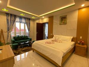 a bedroom with a bed and a living room at An Na Bình Homestay in Hoi An