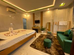 a hotel room with a bed and a couch at An Na Bình Homestay in Hoi An
