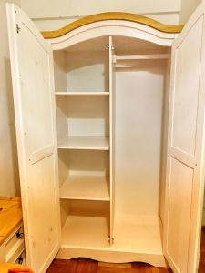a white cupboard with shelves in a room at apto 1 dormitorio con garaje in Montevideo