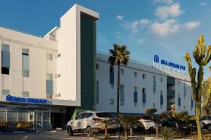 a hotel with cars parked in front of it at MIA Urban Fès in Fez