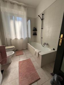 a bathroom with a tub and a toilet and a sink at Posticino apartment in Soave +11 photos