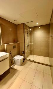 a bathroom with a shower and a toilet and a sink at Burj Royale Lux 2-bedroom apartment with the best Burj Khalifa view in Dubai