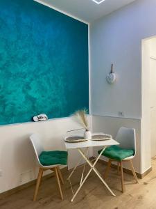 a dining room with a table and two chairs at Carruzzata 2 in Bagheria