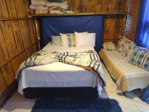 a bedroom with a bed with a blue headboard at Casa bellavista in Resende