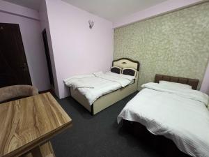 A bed or beds in a room at Hotel Shivaya