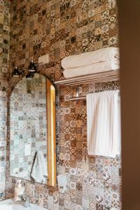a bathroom with a mirror and a sink at Lodge Austral in Puerto Natales