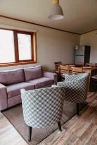 a living room with a couch and a table at Lodge Austral in Puerto Natales