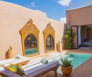 a villa with a swimming pool and a house at Cumin Home in Tagadirt Alkadi