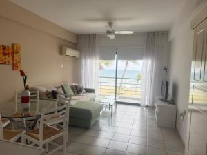 a living room with a view of the ocean at Krasas Beach Apartments in Larnaca