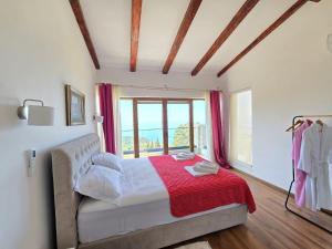 a bedroom with a bed with a red blanket and a window at Villa Trend, Budva, Kuljače in Budva +34 photos