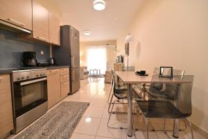 a kitchen with a table and a dining room at Sweet Puzzle in Preveza