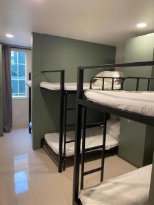 a room with three bunk beds in a room at Hood Pattaya in Pattaya