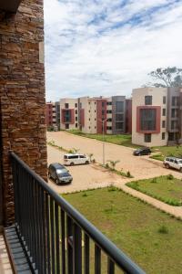 a balcony with a view of a parking lot at Comfortable Entebbe Condo by the Lake in Entebbe