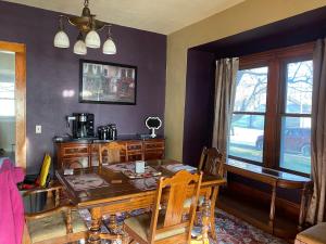 a dining room with a wooden table and a window at Getaway with a small town feel in Currie