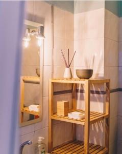 a bathroom with wooden shelves with bowls and utensils at Casa Monki in Raposeira