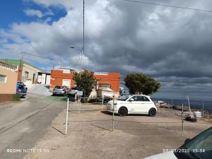 a white car is parked in a parking lot at Casa Relajación in Santa Cruz de Tenerife