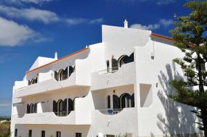 a white building with a tree in front of it at Tonel Apartments in Sagres +76 photos