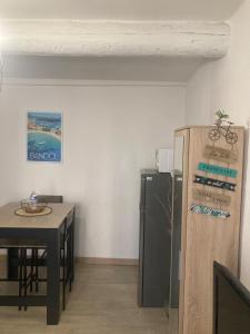 a kitchen with a small table and a refrigerator at Bandol Studio à deux pas du port in Bandol +3 photos