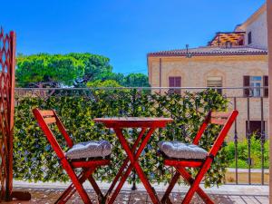two red chairs and a table on a balcony at Tra Onde & Vicoli - Parcheggio PRIVATO in Porto Recanati