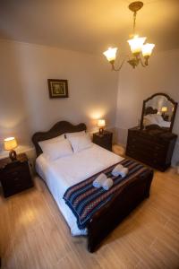 a bedroom with a bed with two teddy bears on it at Casa Gabriel Barbosa in Lagoa