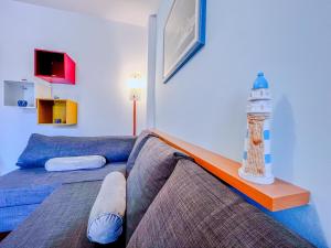 a room with a bed and a lighthouse on a table at Tra Onde & Vicoli - Parcheggio PRIVATO in Porto Recanati