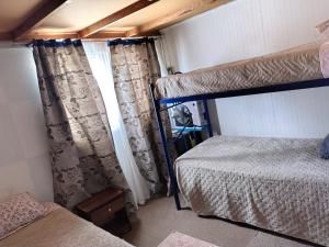 a bedroom with two bunk beds and a window at Guillermo Marconi in Los Ángeles