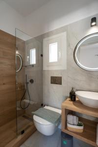 a bathroom with a shower and a toilet and a sink at Irini's Poiēma in Lefkes