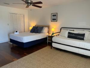 a bedroom with two beds and a ceiling fan at Quiet Retreat-Perdido Bay Golf, Perdido-Orange Beach in Pensacola