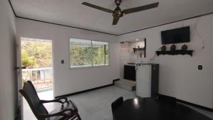 a kitchen with a table and a ceiling fan at GiGi House 2 in Taganga