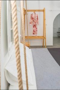 a swing with a dress hanging in a room at The beautiful Plaka in Plaka Milou