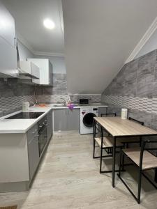 a kitchen with a table and a washer and dryer at Sony Apartments in Lisbon