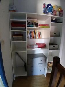 a white book shelf with drawers and books at Maisonnette n 43" La Tortue " in Frontignan