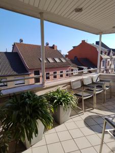 a balcony with chairs and a view of buildings at Hotel Walzwerk in Dillingen an der Saar +36 photos