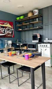 a kitchen with a wooden table with two chairs at Minicasas La Villa in Santa Sofía +7 photos
