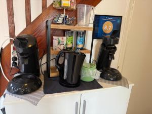 a counter with a coffee maker on a shelf at Domi's Gästehaus in Bergheim