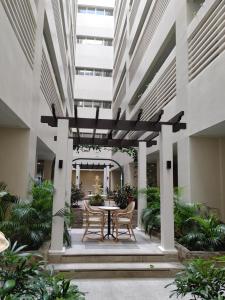 a courtyard with a table and chairs in a building at Saint Honore Megaworld in Iloilo City