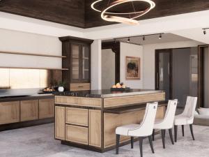 a kitchen with a large island with white chairs at Sanggraloka Ubud in Ubud