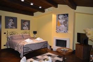 a bedroom with a bed and a fireplace at Domus Telesio Bed & Breakfast in Cosenza