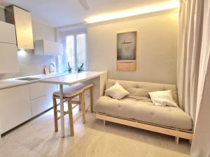 a living room with a couch next to a kitchen at Lecco Antico Pozzo - Modern Suite in Lecco