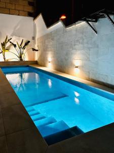 a swimming pool with blue water in a building at Villa Margarita ocean view and private heated pool in Adeje