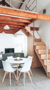 a dining room with a white table and white chairs at Mezzanine with courtyard in Porto in Porto