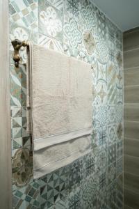 a tiled bathroom with a window and towels at Tzànnou farm residence in Mytilini