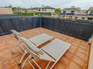 a patio with two chairs and a table on a balcony at The Garden House in Alicante